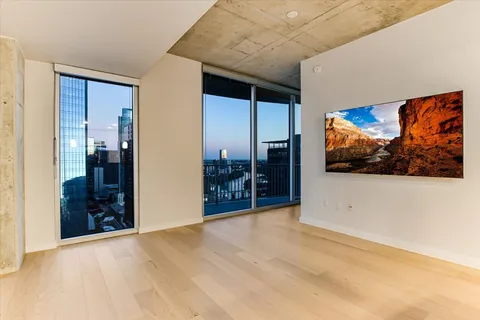 a view of a livingroom with furniture and cabinet with a flat screen tv