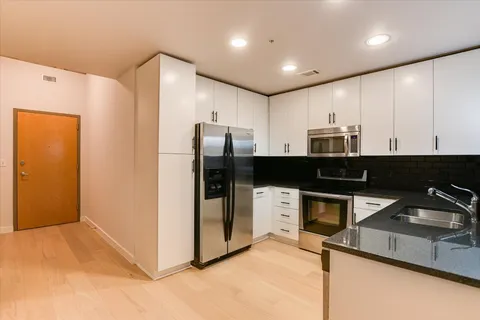 a kitchen with stainless steel appliances a refrigerator and a sink