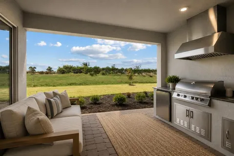 a balcony with furniture and a floor to ceiling window
