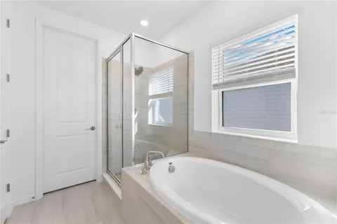 a bathroom with a bathtub and a shower