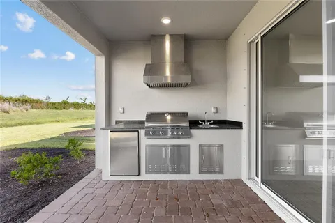 a kitchen with stainless steel appliances granite countertop a stove and a refrigerator