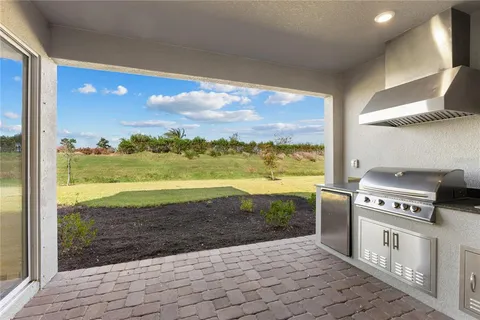 a view of a room with kitchen island stainless steel appliances and cabinets