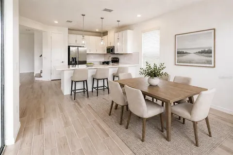 a view of a dining room with furniture and wooden floor
