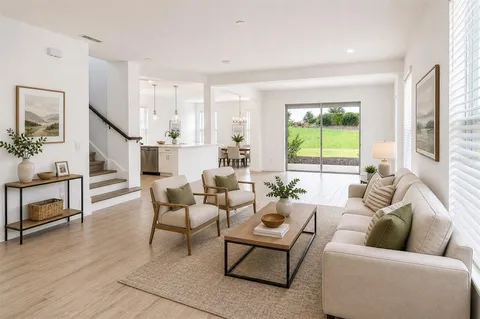 a living room with furniture and a potted plant