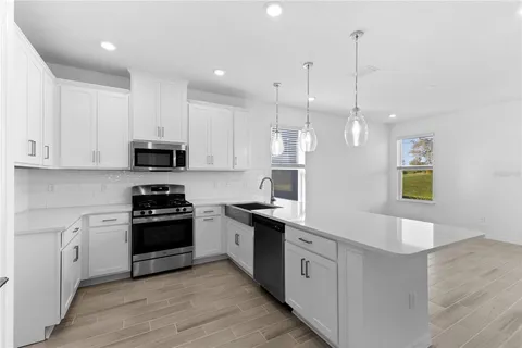 a kitchen with stainless steel appliances and white cabinets