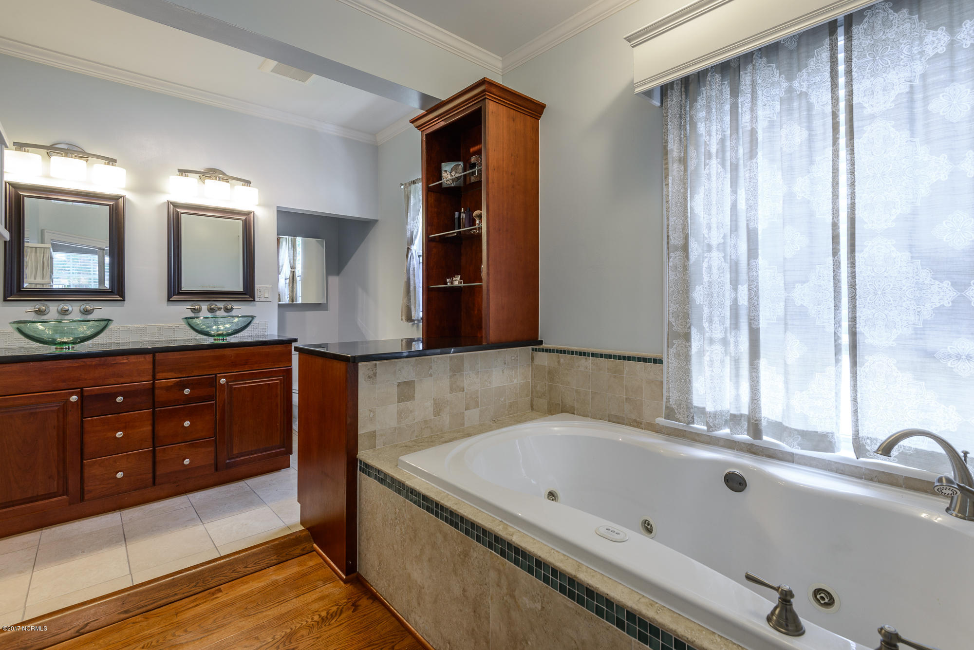 1100 West Rock Spring Road Greenville, NC 27858 - Photo 24 of 51 remodeled en suite master bathroom with dual glass bowl sinks