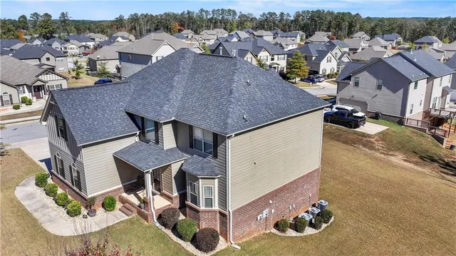 an aerial view of a house with swimming pool and mountain view