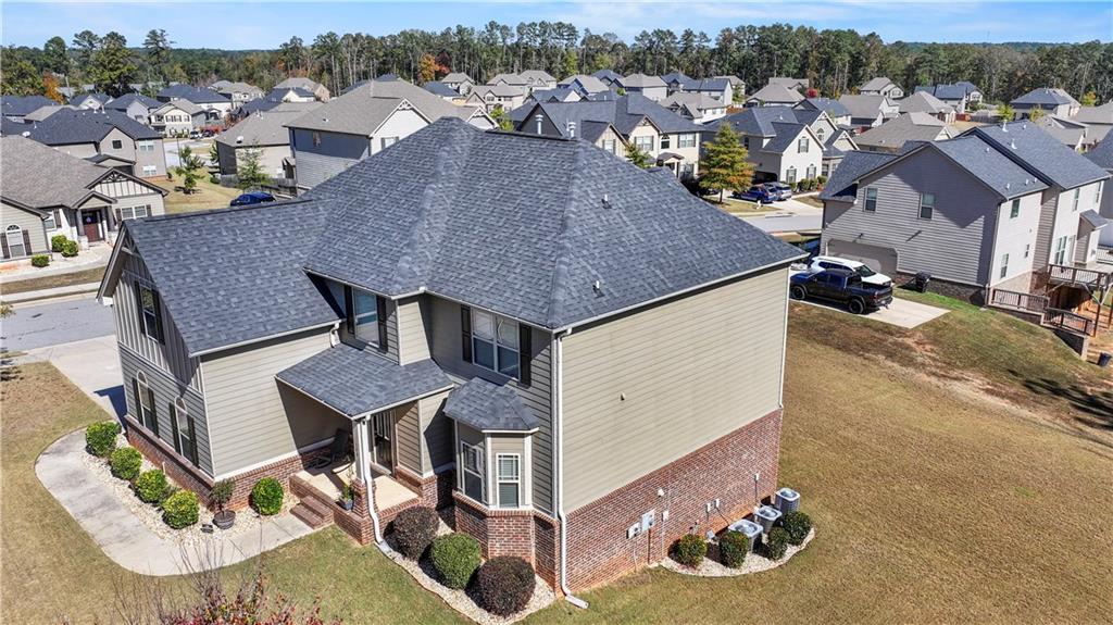 an aerial view of a house with swimming pool and mountain view