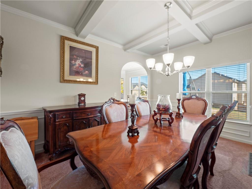 190 Silver Ridge Road Covington, GA 30016 - Photo 11 of 51 a dining room filled chandelier and wooden floor