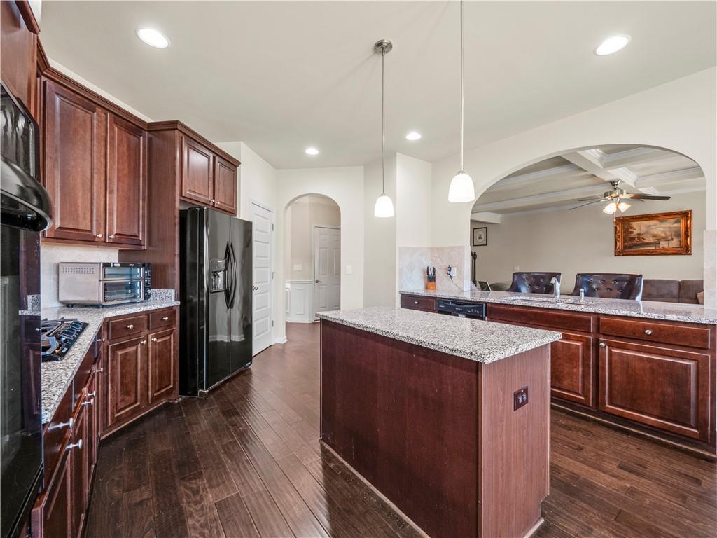 190 Silver Ridge Road Covington, GA 30016 - Photo 14 of 51 a kitchen with stainless steel appliances kitchen island granite countertop a stove refrigerator and cabinets