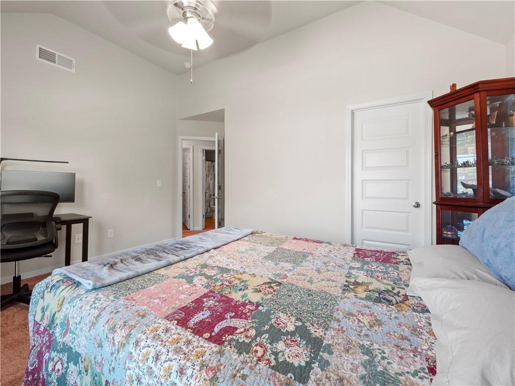 190 Silver Ridge Road Covington, GA 30016 - Photo 21 of 51 a bedroom with a bed and a chandelier