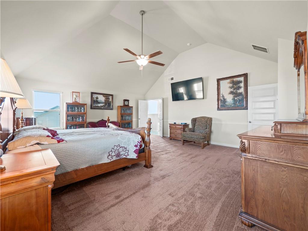 190 Silver Ridge Road Covington, GA 30016 - Photo 28 of 51 a spacious bedroom with a bed and a chandelier