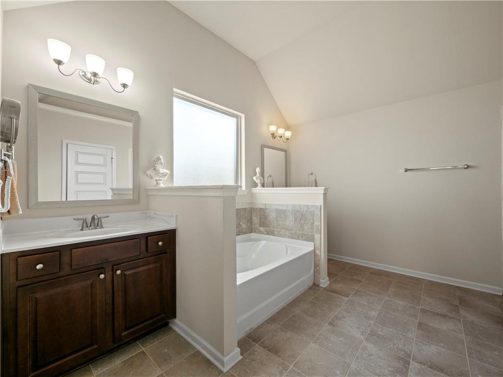 190 Silver Ridge Road Covington, GA 30016 - Photo 30 of 51 a bathroom with a tub sink and mirror