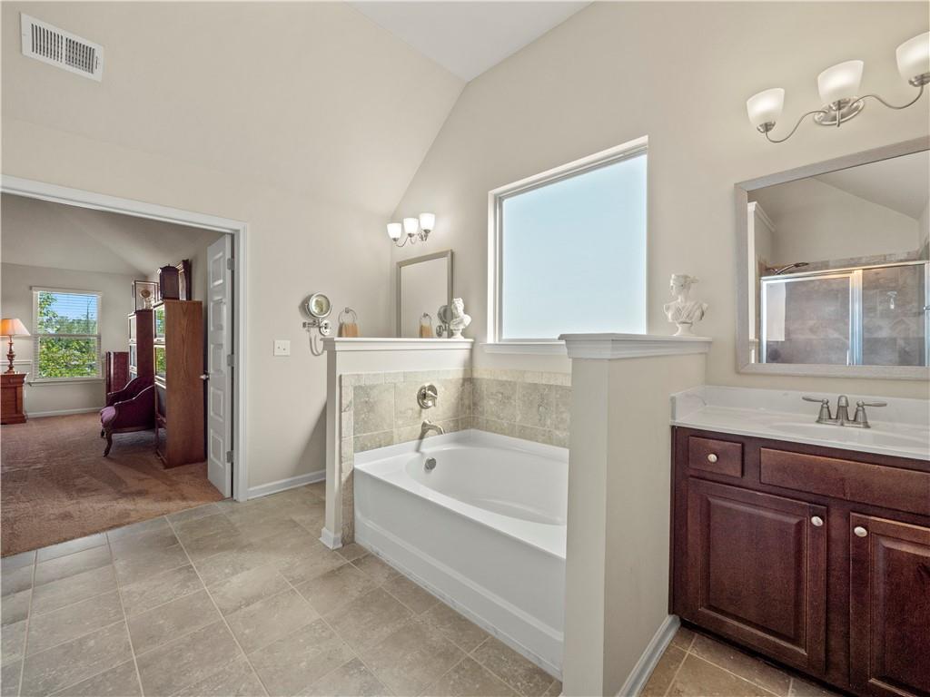190 Silver Ridge Road Covington, GA 30016 - Photo 31 of 51 a bathroom with a tub sink and mirror