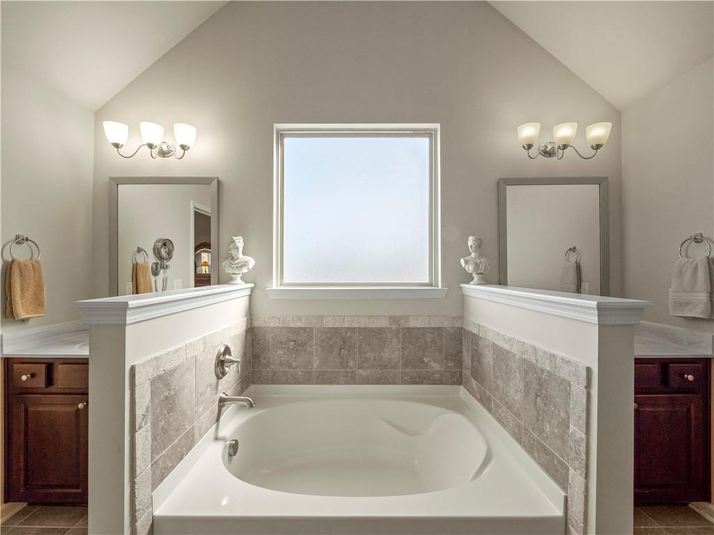 190 Silver Ridge Road Covington, GA 30016 - Photo 32 of 51 a bathroom with a sink a mirror and a bathtub