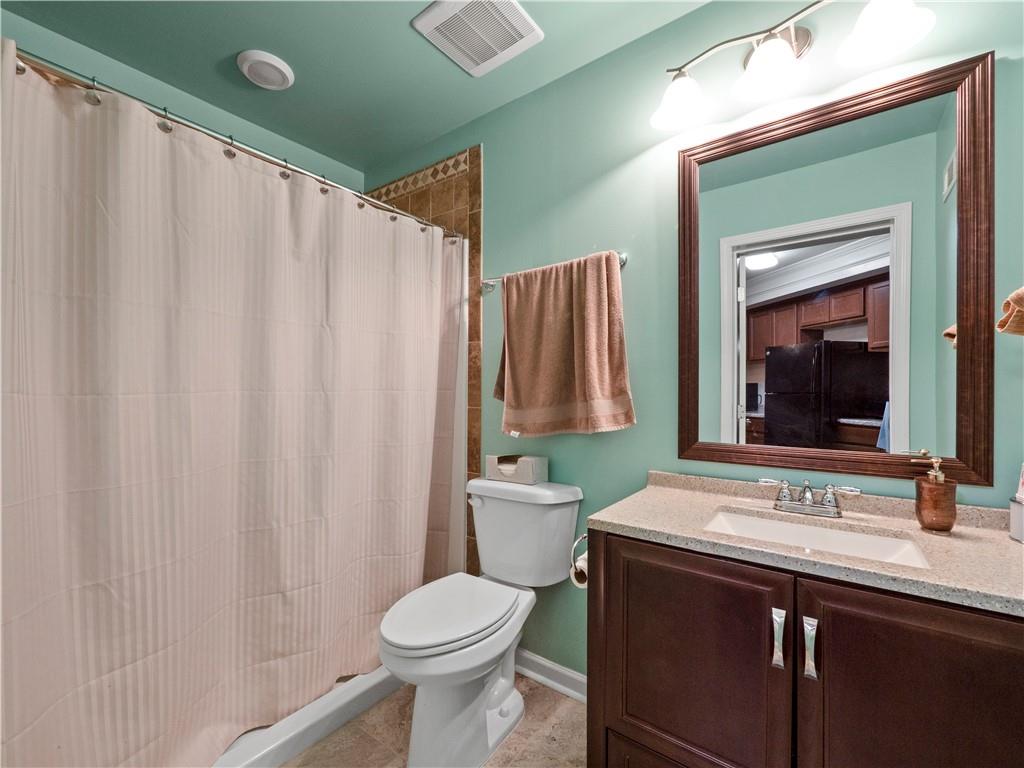 190 Silver Ridge Road Covington, GA 30016 - Photo 36 of 51 a bathroom with a sink a toilet and a mirror