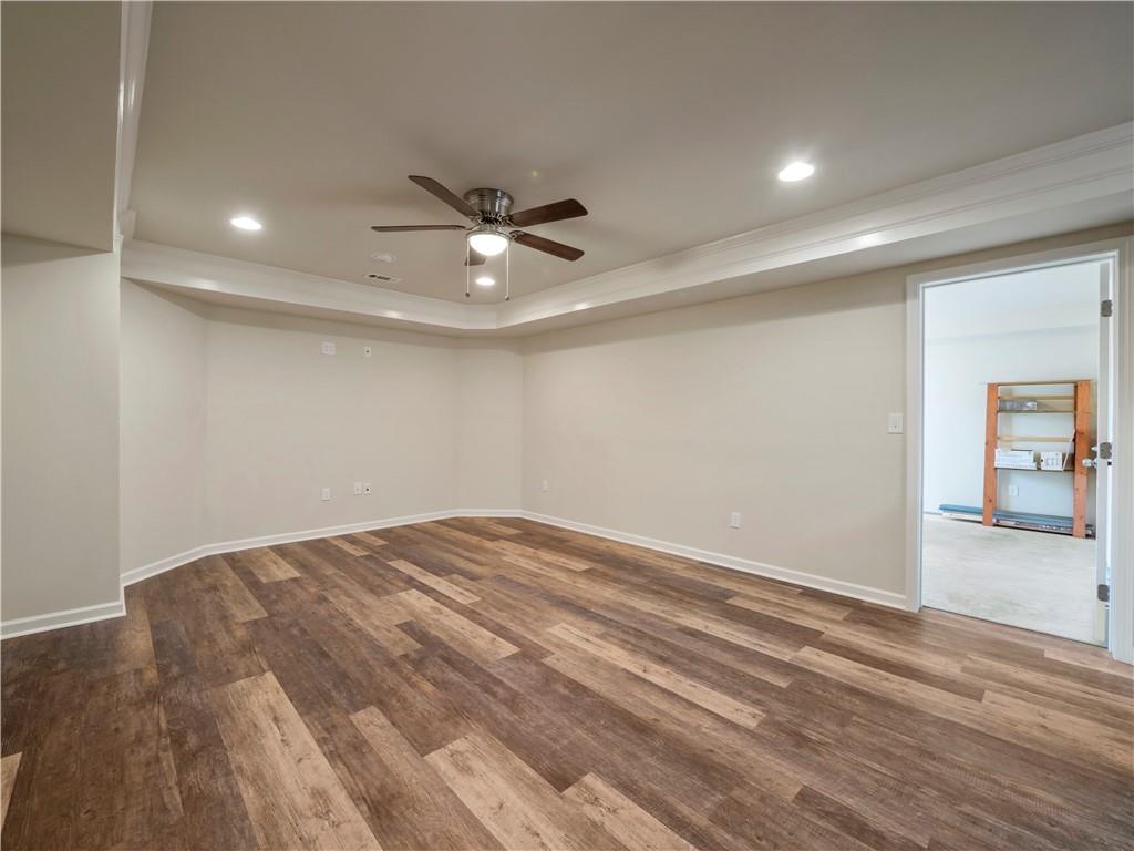 190 Silver Ridge Road Covington, GA 30016 - Photo 48 of 51 an empty room with wooden floor and windows