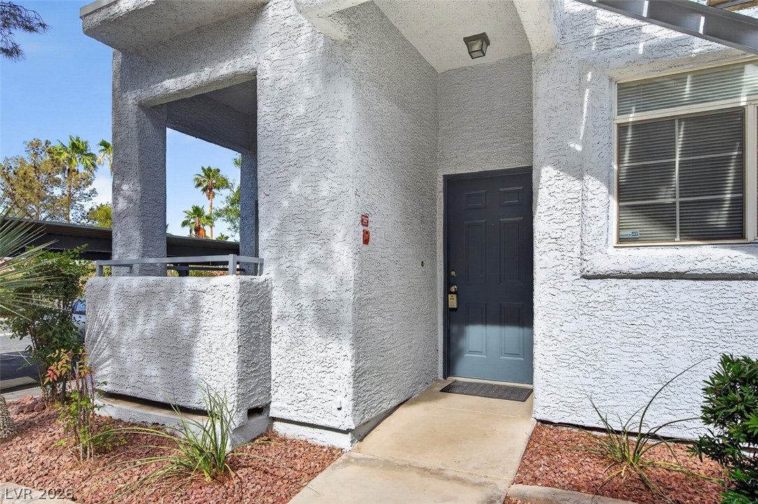 2201 Ramsgate Drive, Unit 1011 Henderson, NV 89074 - Photo 4 of 40 A welcoming entry path leads to this unit, accented by drought-tolerant landscaping and a view of palm trees.