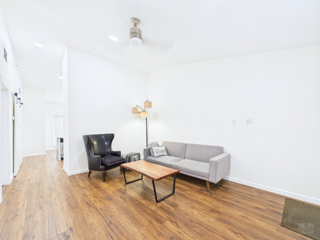 2216 San Gabriel Street, Unit 305 Austin, TX 78705 - Photo 16 of 38 a living room with furniture and wooden floor