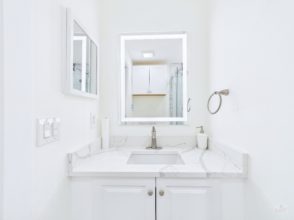 2216 San Gabriel Street, Unit 305 Austin, TX 78705 - Photo 17 of 38 a bathroom with a sink and a mirror