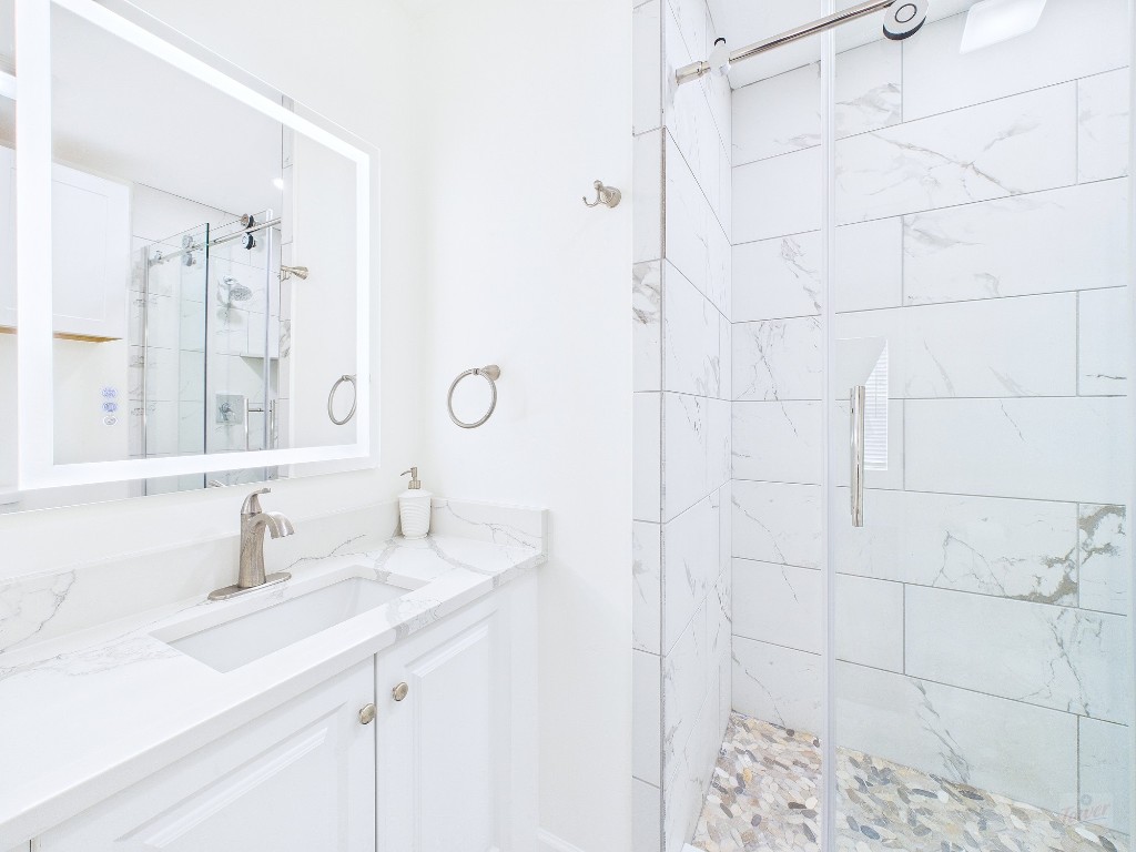 2216 San Gabriel Street, Unit 305 Austin, TX 78705 - Photo 18 of 38 a bathroom with double sink and a mirror