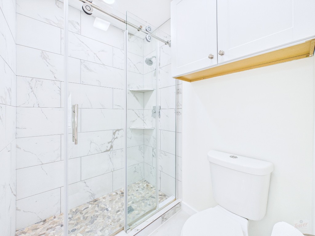 2216 San Gabriel Street, Unit 305 Austin, TX 78705 - Photo 19 of 38 a bathroom with a shower and toilet