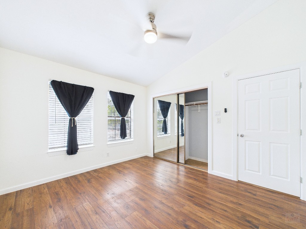 2216 San Gabriel Street, Unit 305 Austin, TX 78705 - Photo 21 of 38 an empty room with wooden floor and windows