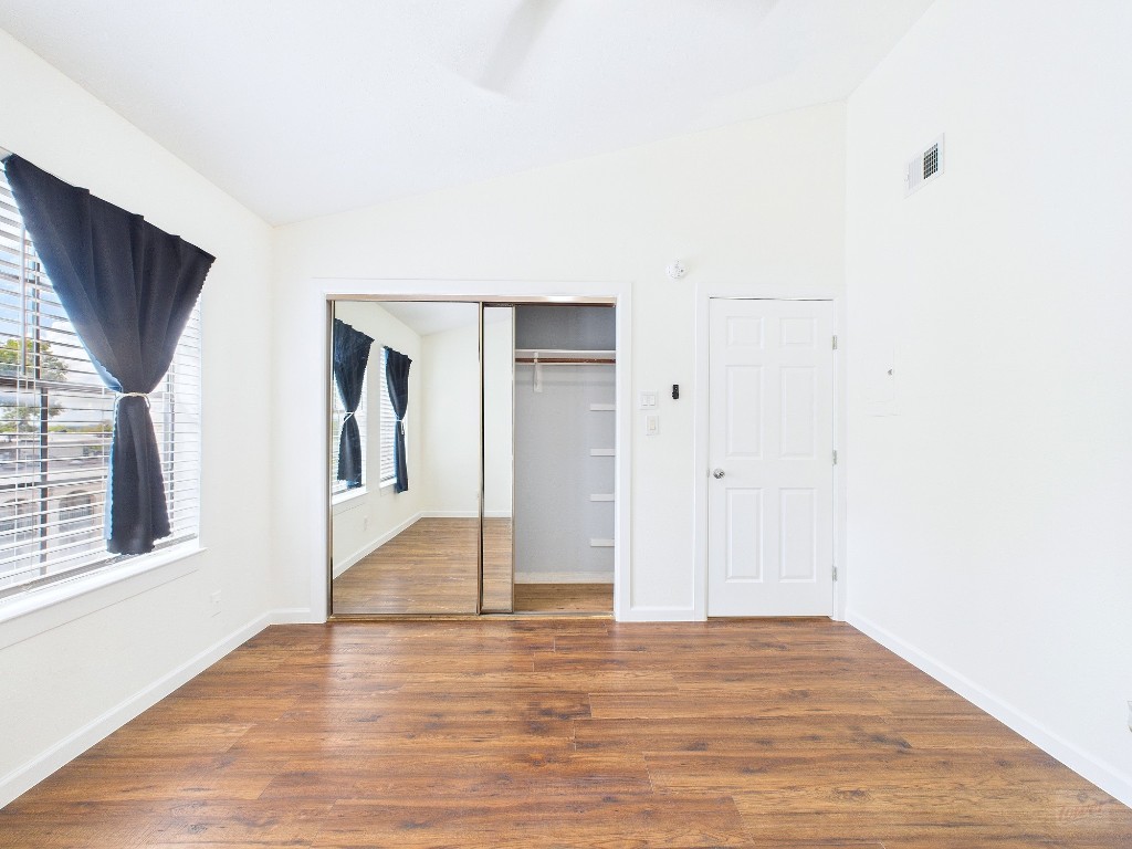 2216 San Gabriel Street, Unit 305 Austin, TX 78705 - Photo 22 of 38 a view of an empty room with wooden floor and a window