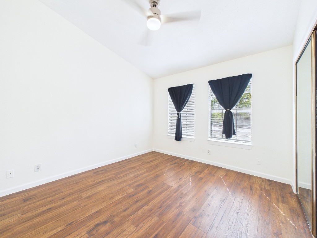 2216 San Gabriel Street, Unit 305 Austin, TX 78705 - Photo 25 of 38 an empty room with wooden floor and windows