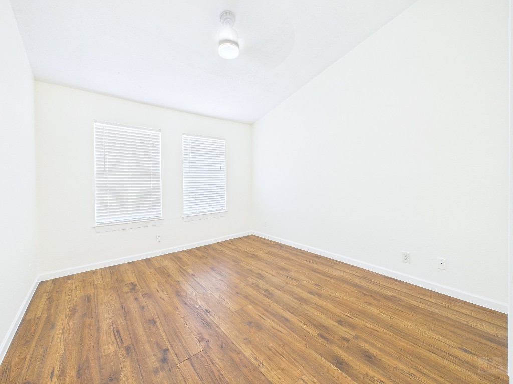 2216 San Gabriel Street, Unit 305 Austin, TX 78705 - Photo 26 of 38 an empty room with wooden floor and windows