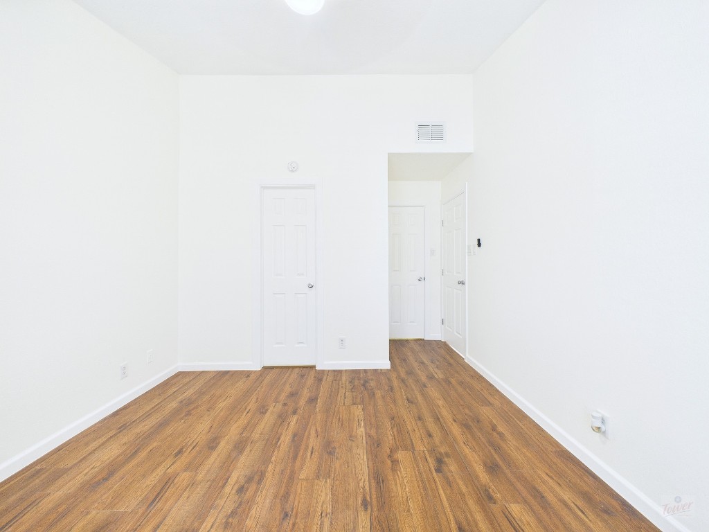 2216 San Gabriel Street, Unit 305 Austin, TX 78705 - Photo 28 of 38 a view of a room with wooden floor and white walls