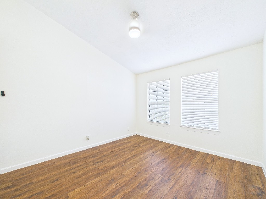 2216 San Gabriel Street, Unit 305 Austin, TX 78705 - Photo 30 of 38 an empty room with wooden floor and windows