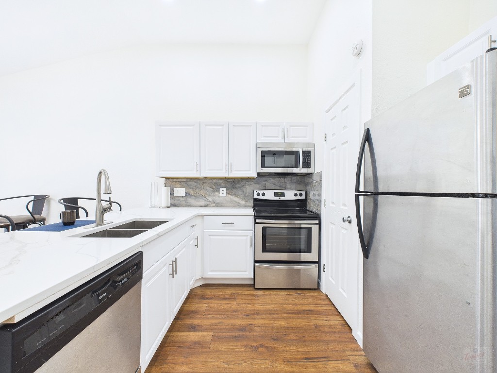 2216 San Gabriel Street, Unit 305 Austin, TX 78705 - Photo 4 of 38 a kitchen with a sink appliances and cabinets