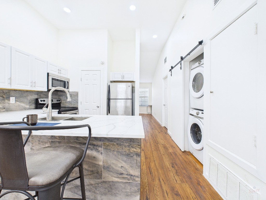 2216 San Gabriel Street, Unit 305 Austin, TX 78705 - Photo 5 of 38 a living room with furniture and a wooden floor
