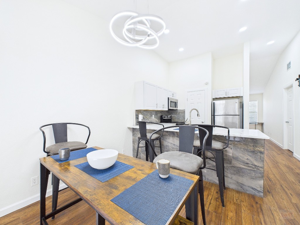 2216 San Gabriel Street, Unit 305 Austin, TX 78705 - Photo 9 of 38 a view of a dining room with furniture and wooden floor