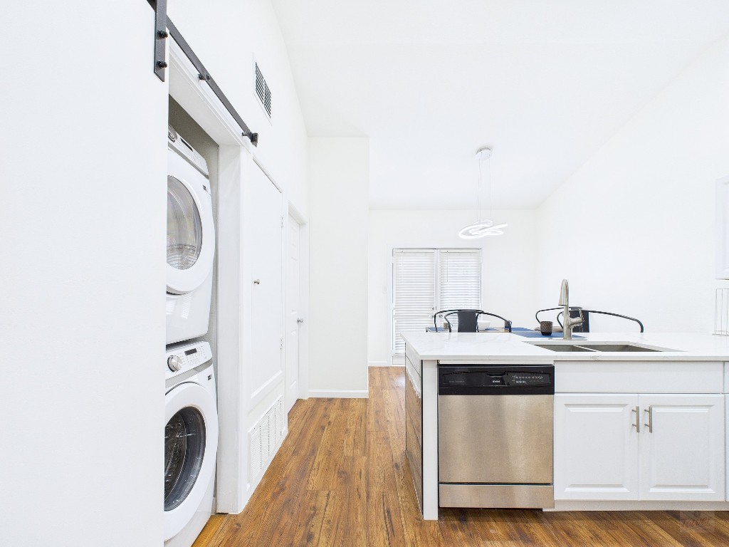 2216 San Gabriel Street, Unit 305 Austin, TX 78705 - Photo 10 of 38 a kitchen with stainless steel appliances granite countertop a stove a sink and a microwave