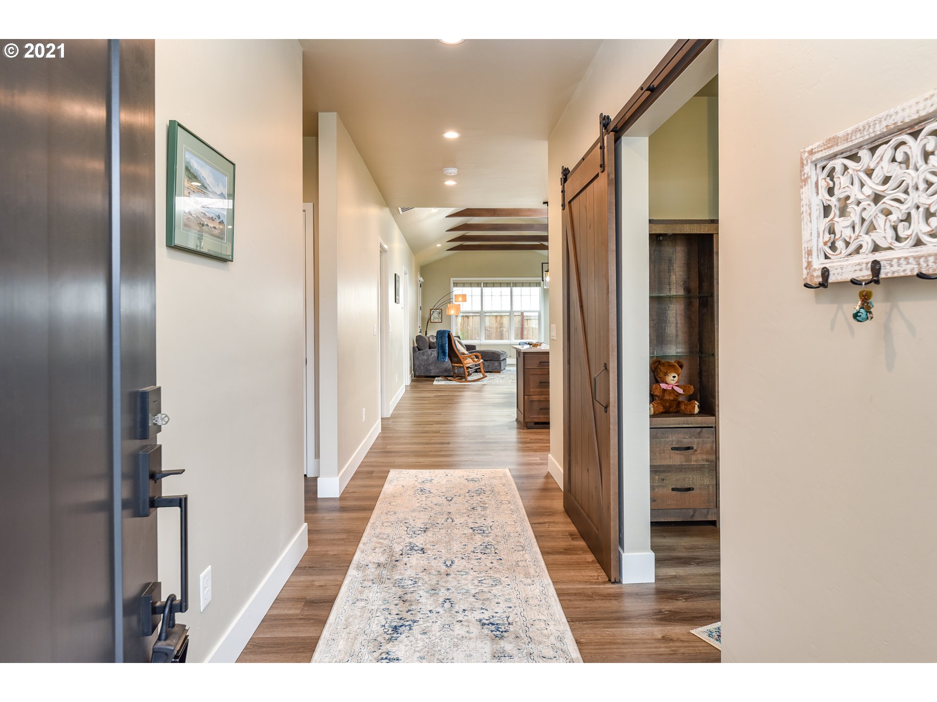 978 South 47th Street Springfield, OR 97478 - Photo 7 of 32 view of a hallway with wooden floor and living room