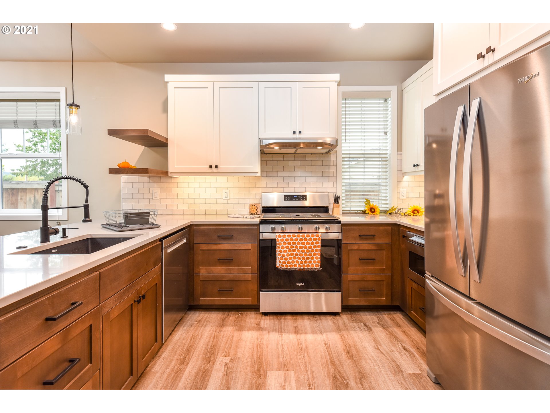 978 South 47th Street Springfield, OR 97478 - Photo 9 of 32 a kitchen with wooden floors and stainless steel appliances