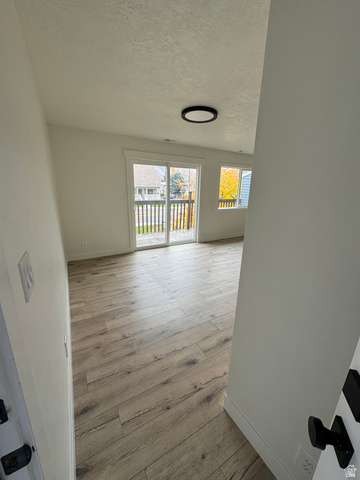 608 South 500 West, Unit 3 Provo, UT 84601 - Photo 4 of 35 Spacious living area featuring wood-finish flooring, white walls, and a contemporary flush-mount ceiling light