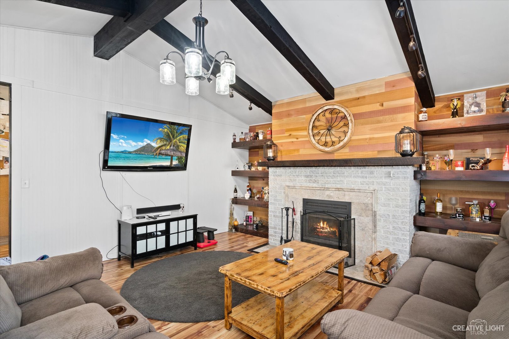232 Reid Road Genoa, IL 60135 - Photo 11 of 25 a living room with furniture a flat screen tv and a fireplace