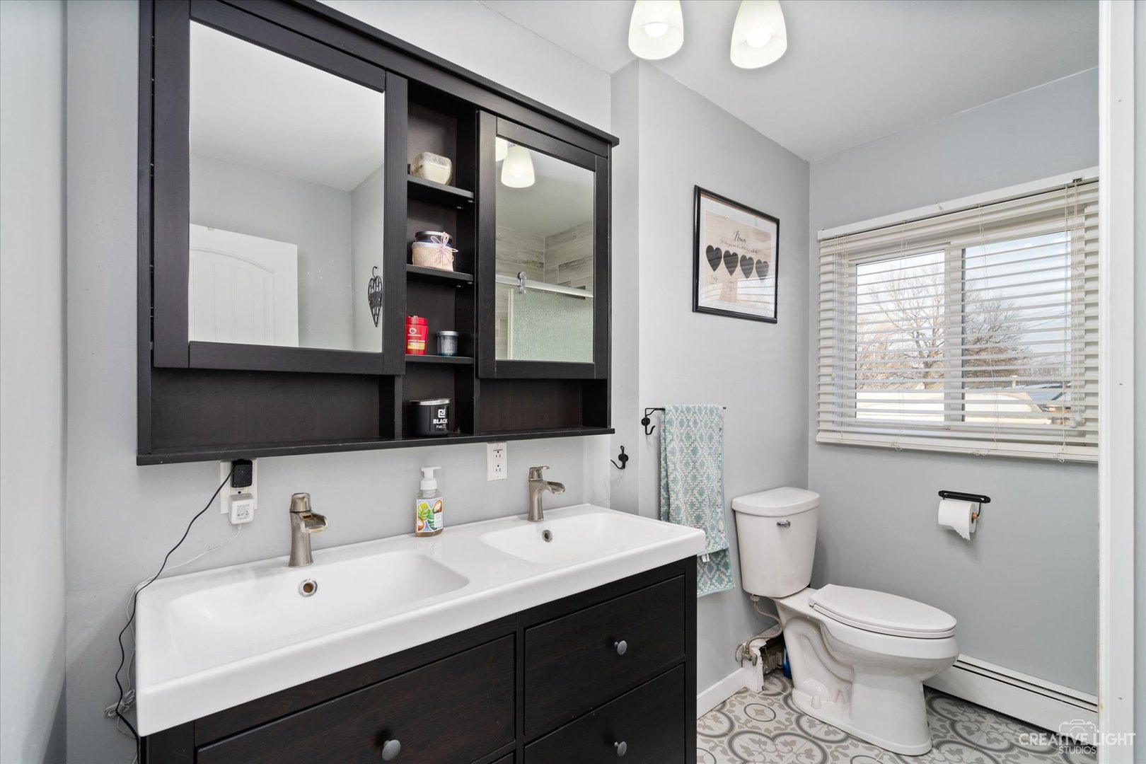 232 Reid Road Genoa, IL 60135 - Photo 16 of 25 a bathroom with a toilet sink and mirror