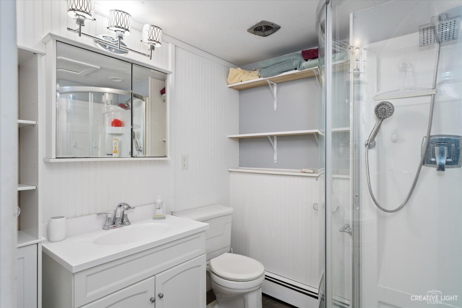 232 Reid Road Genoa, IL 60135 - Photo 20 of 25 a bathroom with a toilet a sink and a mirror