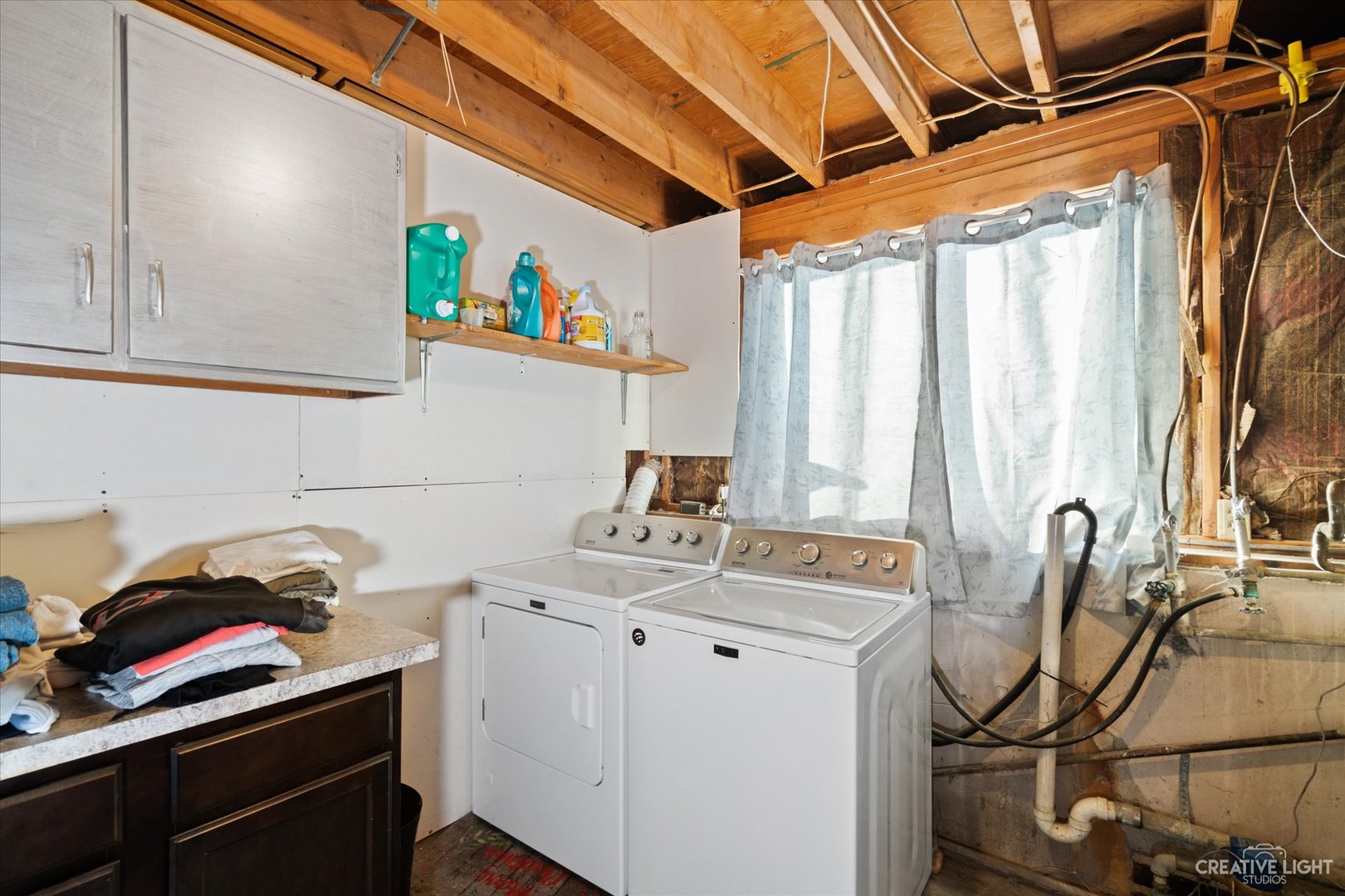 232 Reid Road Genoa, IL 60135 - Photo 21 of 25 a utility room with a sink dryer and washer