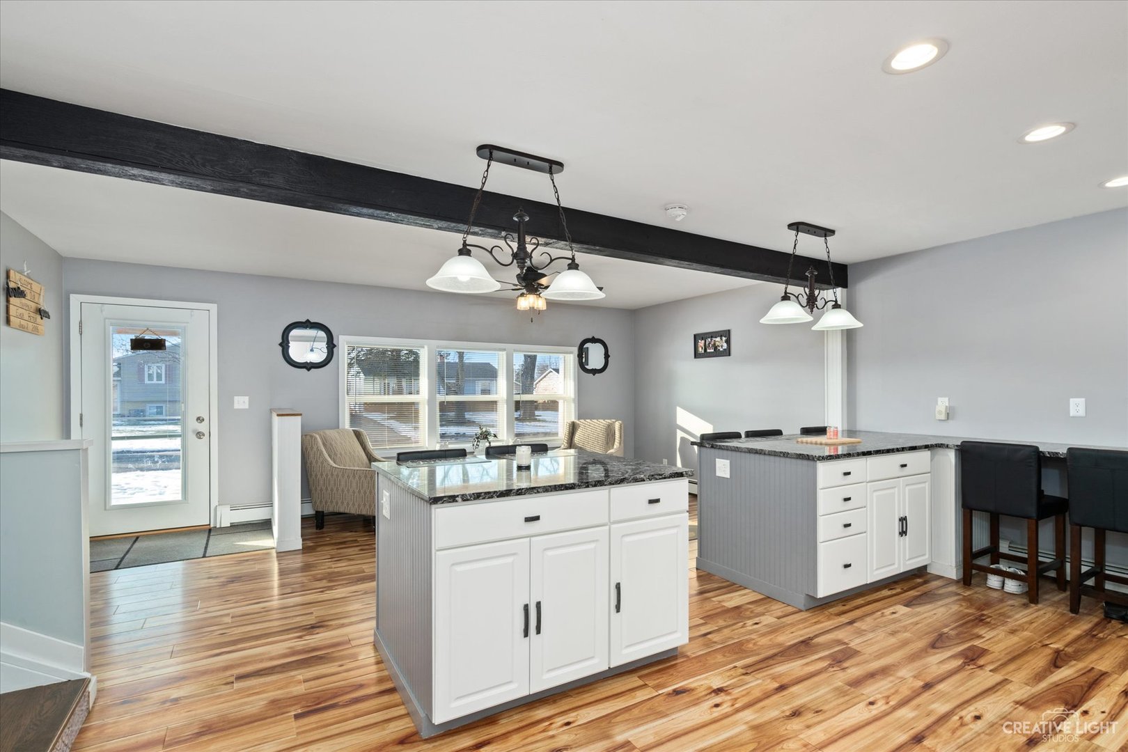 232 Reid Road Genoa, IL 60135 - Photo 8 of 25 a kitchen with granite countertop a stove cabinets and wooden floor