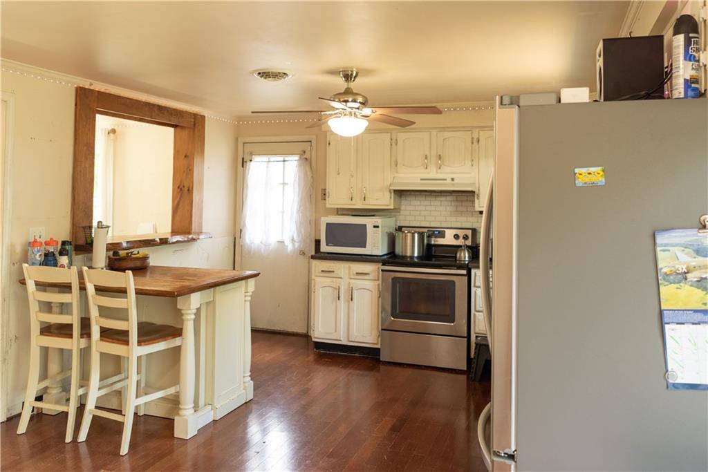 216 Ruth Drive Home, PA 15747 - Photo 5 of 15 a kitchen with a center island wooden floor and stainless steel appliances