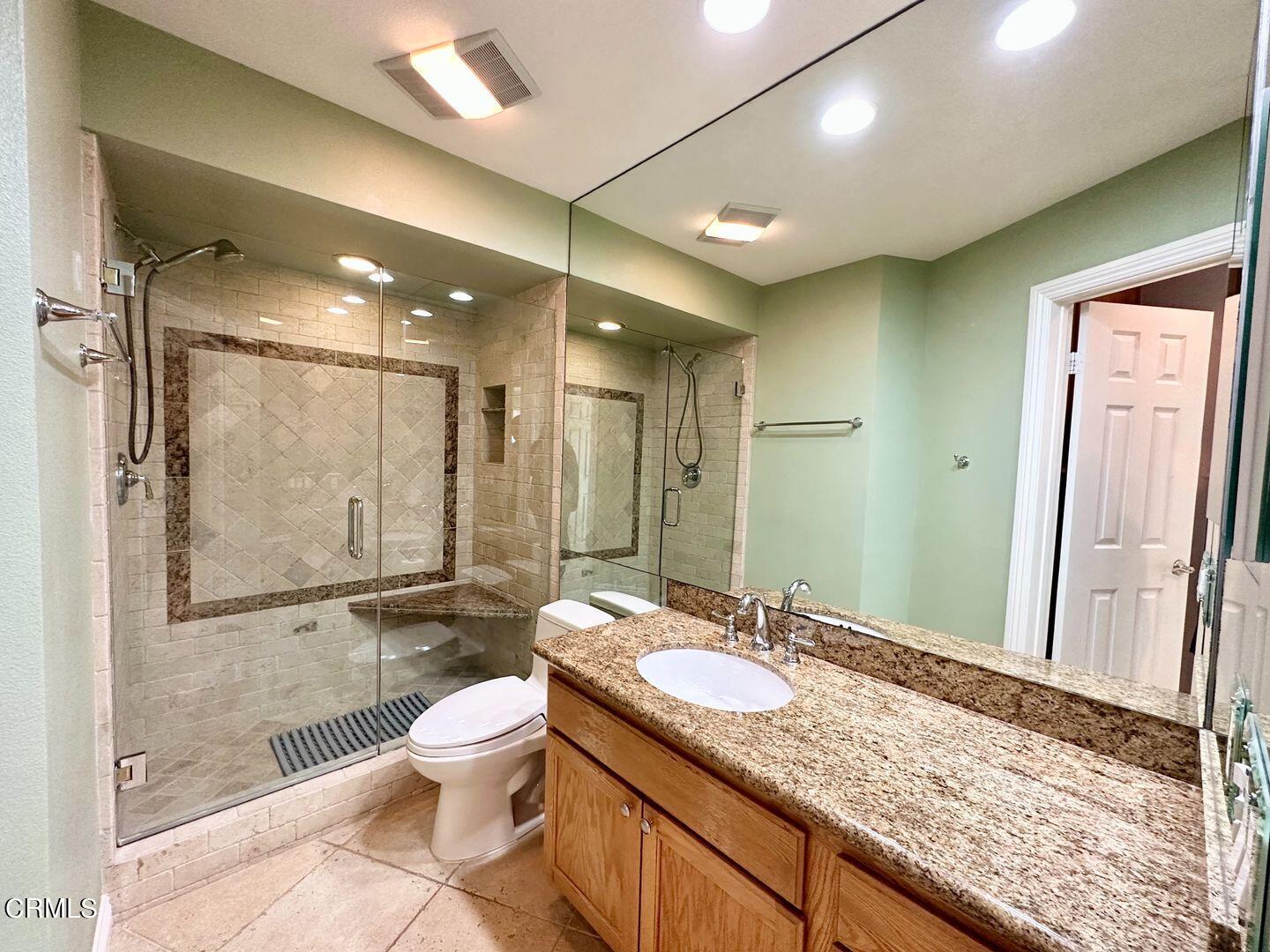 2901 Peninsula Road, Unit 348 Oxnard, CA 93035 - Photo 13 of 22 a bathroom with a granite countertop sink toilet a mirror and shower