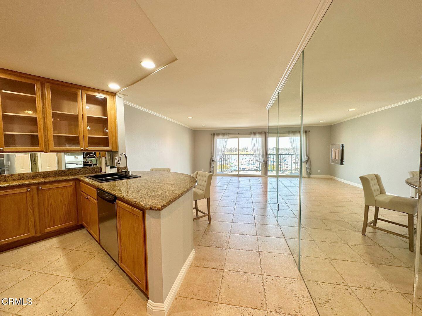2901 Peninsula Road, Unit 348 Oxnard, CA 93035 - Photo 3 of 22 a kitchen with stainless steel appliances granite countertop a stove a sink and a microwave