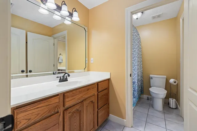 a bathroom with a sink a toilet and a mirror