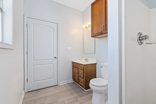 a view of bathroom with a toilet sink and mirror