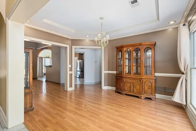 a view of a livingroom with wooden floor and furniture